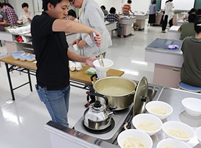 スパイスの味見のためうどんや学生が農場でつくったナスの振る舞い